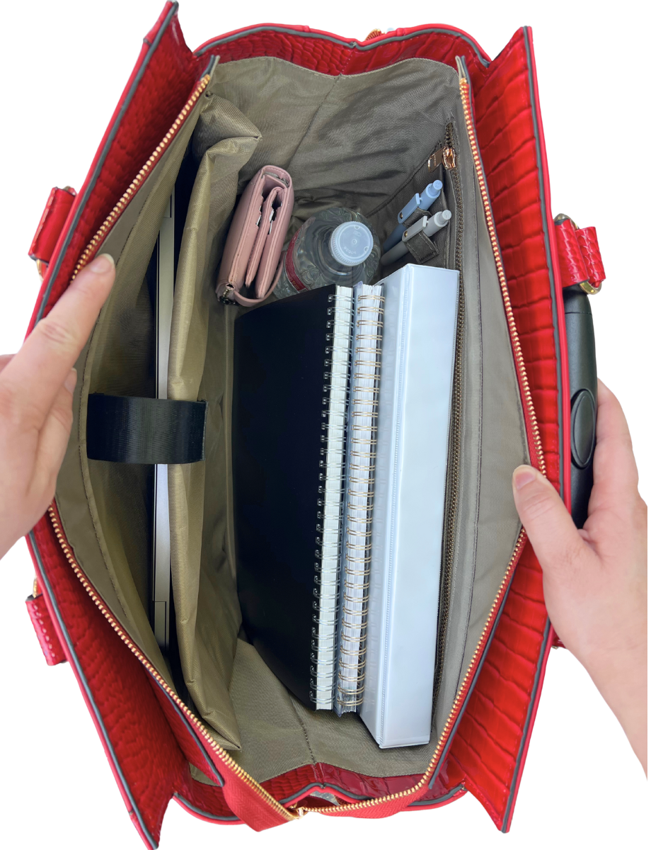 Interior of the red briefcase roller filled with work and travel essentials: a laptop, water bottle, charger, folders, notebooks, wallet, pens, and files. Shows the bag’s ample space and organized compartments for busy professionals on the go. Ideal for women looking for a functional and stylish carry-on work bag, this makes a perfect gift for her and helps eliminate the need to carry heavy totes on your shoulder. This bag also fits travel items like toiletry and makeup bags and travel outfits.