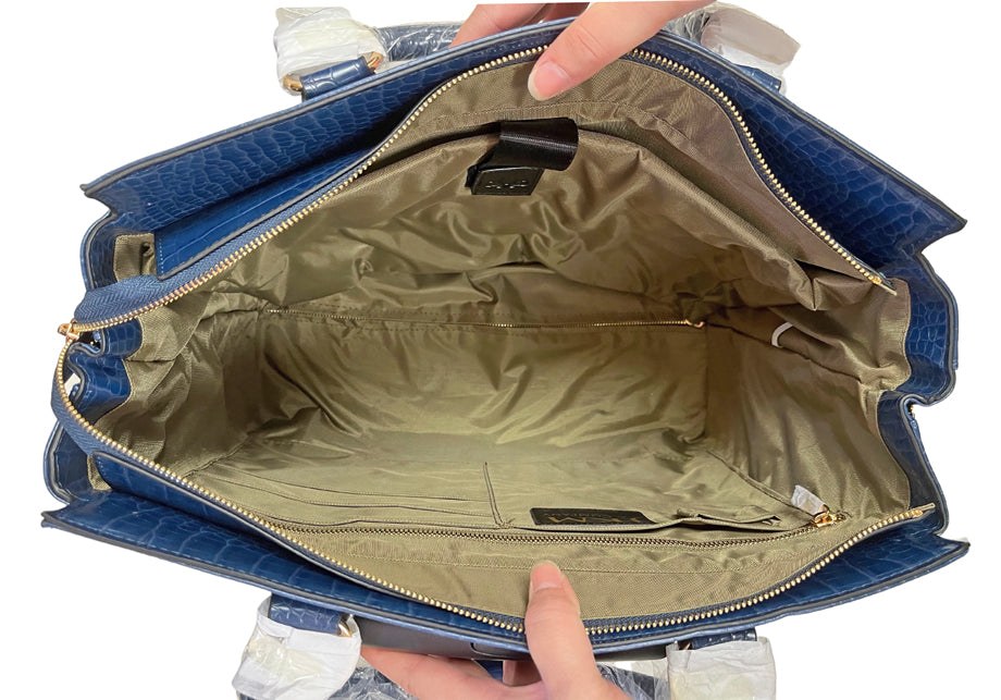 Interior view of the Riviera stylish briefcase with wheels, showcasing a padded built-in laptop sleeve, large zipper compartment, pen holders, four additional pockets, and a spacious interior designed for ultimate organization and protection during travel. Built for organization, this structured bag fits a 15” laptop, documents, and office accessories with ease. Ideal for professionals who want a fashionable roomy work bag that maintains its shape while staying lightweight and mobile on wheels.