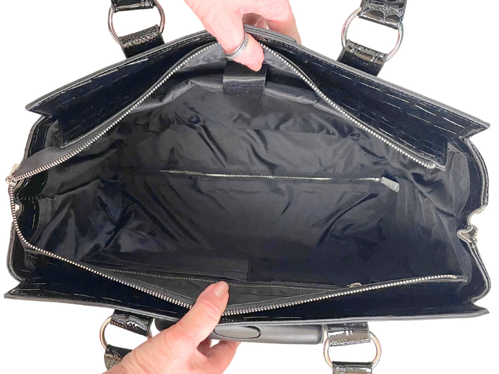 Interior of the rolling briefcase for women, it shows a large space for work and travel essentials and must haves. Fits a laptop, chargers, work books, files, water bottle, lunch bag, planners, a change of clothes, make up bag, pens, or toiletry bag.