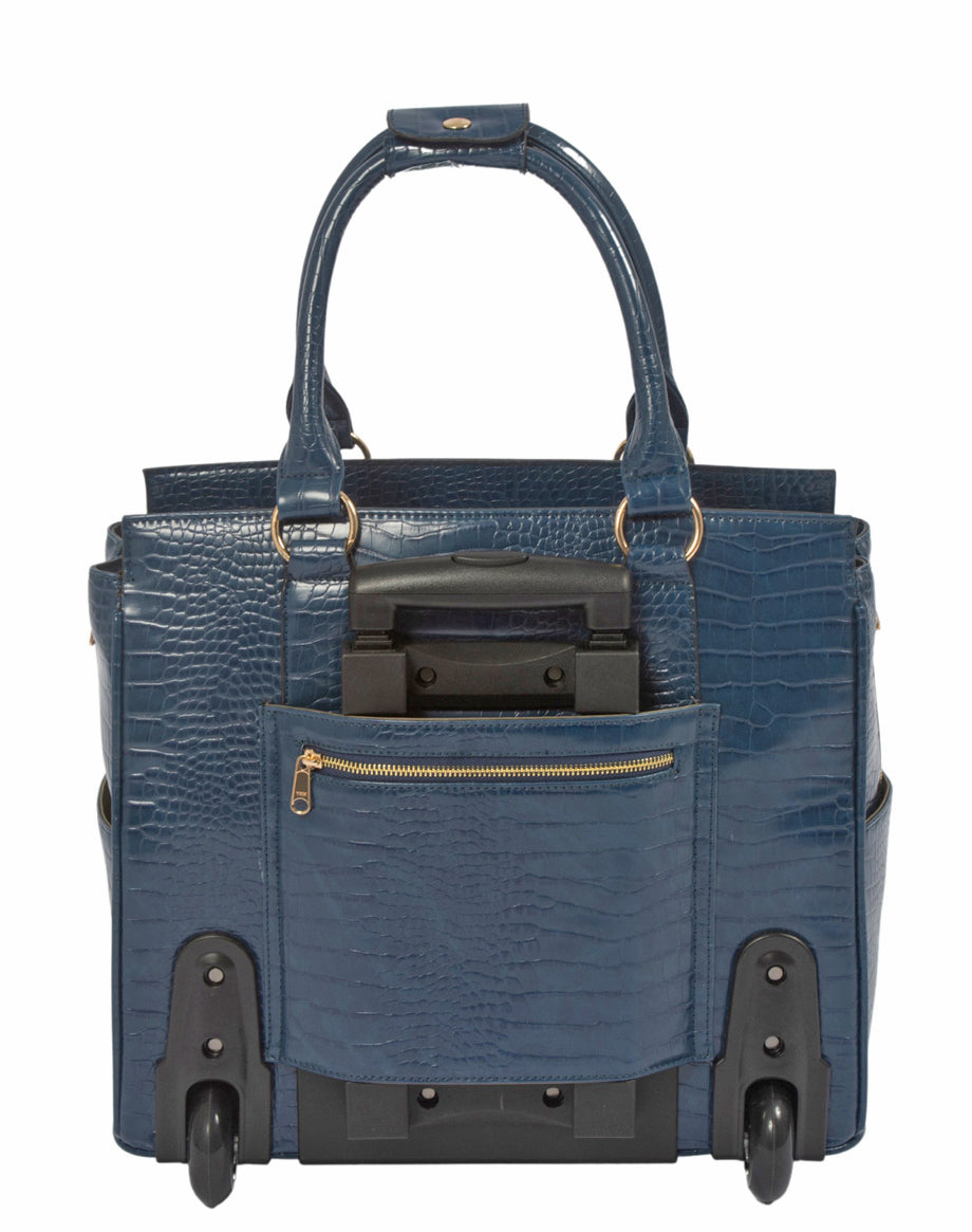 Back view of a midnights blue faux alligator leather laptop tote, featuring two smooth wheels and two front feet for stability. The retractable handle is hidden in a back zipper pocket, while the raised handstraps show its versatility as a handbag. This design offers security and quick-access storage for phones, boarding passes, or work IDs. Lightweight and airport-friendly, it solves the problem of juggling multiple bags while traveling or commuting, especially for businesswomen and educators.