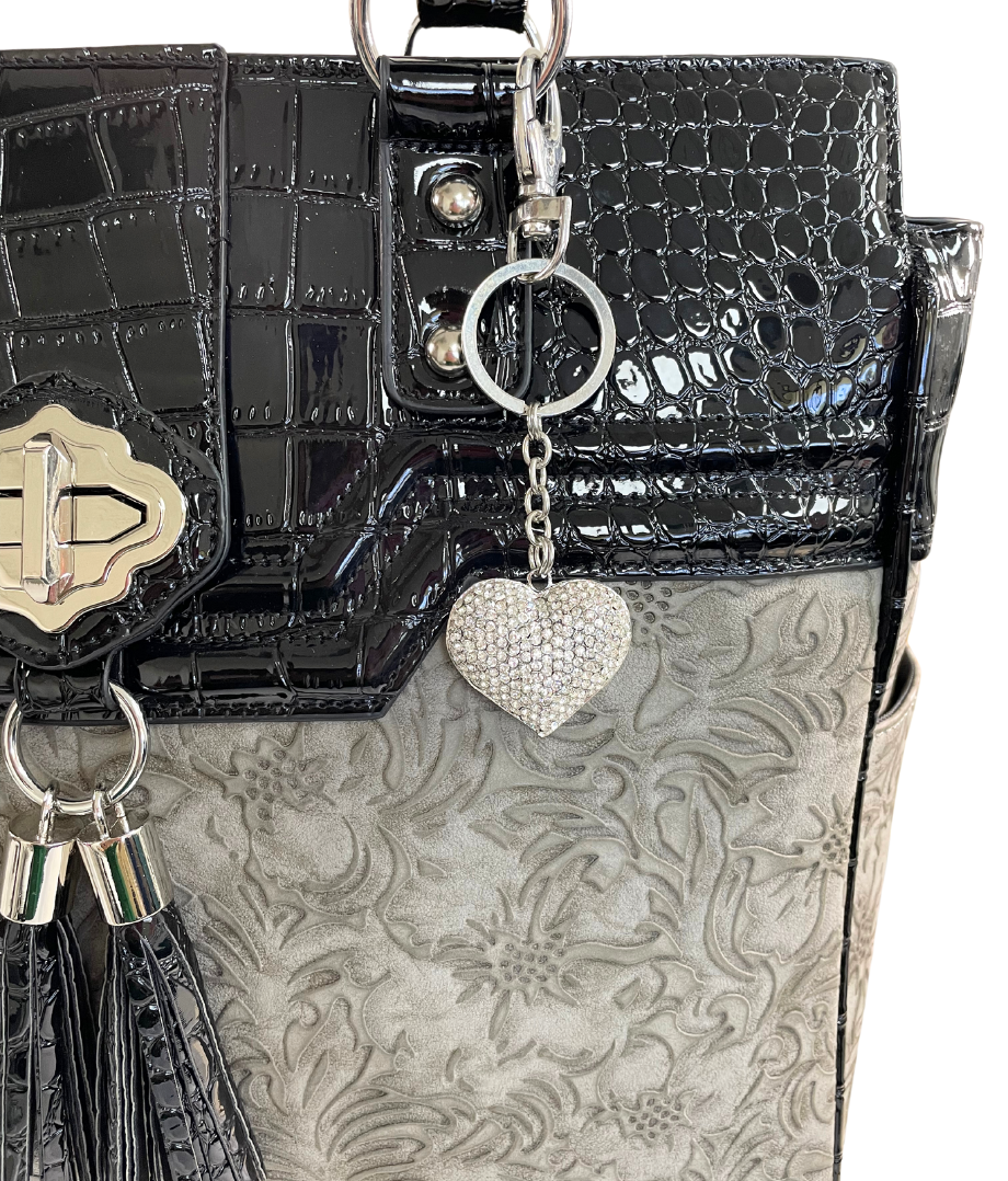 This silver metal heart is the perfect travel bag accessory for her, showing off her style! This charm can be a cute accent on a laptop tote for women as shown in the photo. Perfect for nurses, teachers, moms, lawyers, realtors, students, and anyone looking for a bit of extra bling in their lives!