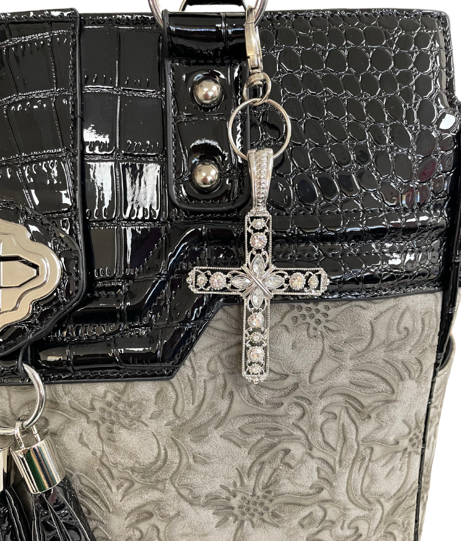 This silver cross charm is a beautiful alternative to a coach charm. As pictured, these cross pendants pair perfectly with our rolling laptop bags but can also be used for car key accessories and wallet accessories.