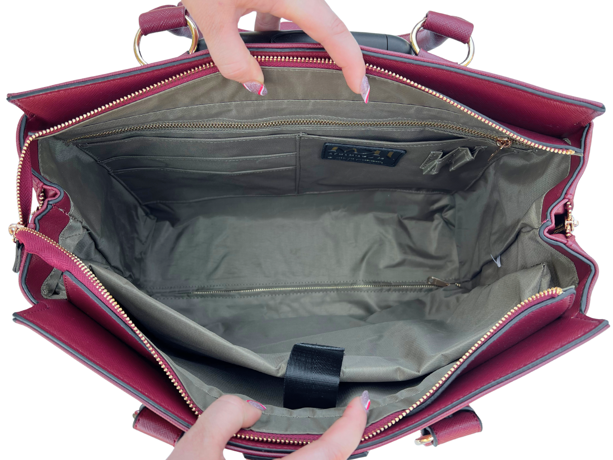 Close-up view of the spacious interior of the Bella Red Rolling Laptop Bag for women, ideal for teachers during the back-to-school season. The interior features a durable light gray lining, multiple organizational pockets including card slots, pen loops, and a zippered compartment, plus a padded laptop sleeve with a secure strap to protect devices. This teacher work bag on wheels easily accommodates lesson plans, textbooks, a lunch bag, and daily school supplies, helping educators stay organized.