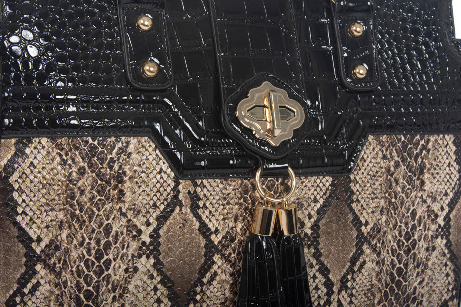 Close up image of the python snake print bag with patent black alligator fabric on top. These totes can be used in place of cosmetic bags to hold your cosmetics as well as clothes for a weekend girls trip.