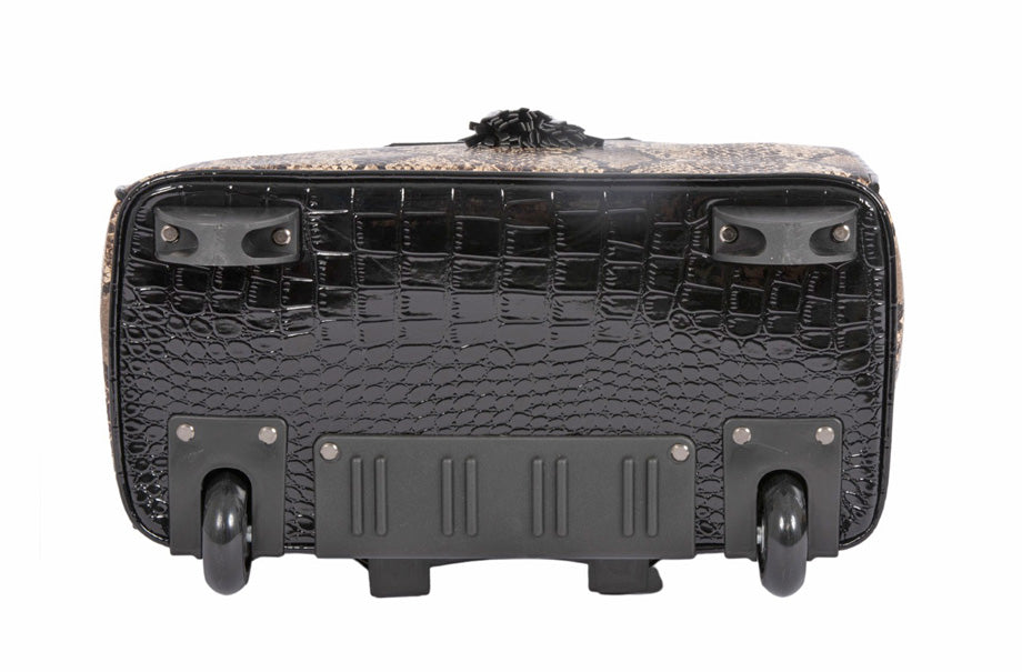 Bottom view of the bag to show off the dark black patent fabric of  the secondary material. Features a retractable handle seen on the back of the bag as well as front bag feet to keep your bag off the floor. Two back wheels allow for smooth travel.