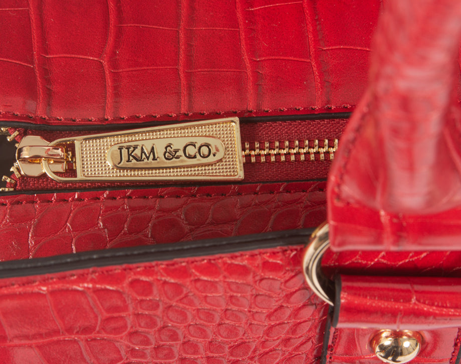 A top view of the branded zipper securing the interior of the work tote. This bag is a perfect university or college bag as it can hold textbooks, notebooks, laptops, water bottles, snacks, pens, a lunch bag, and travel necessities as you commute to classes.