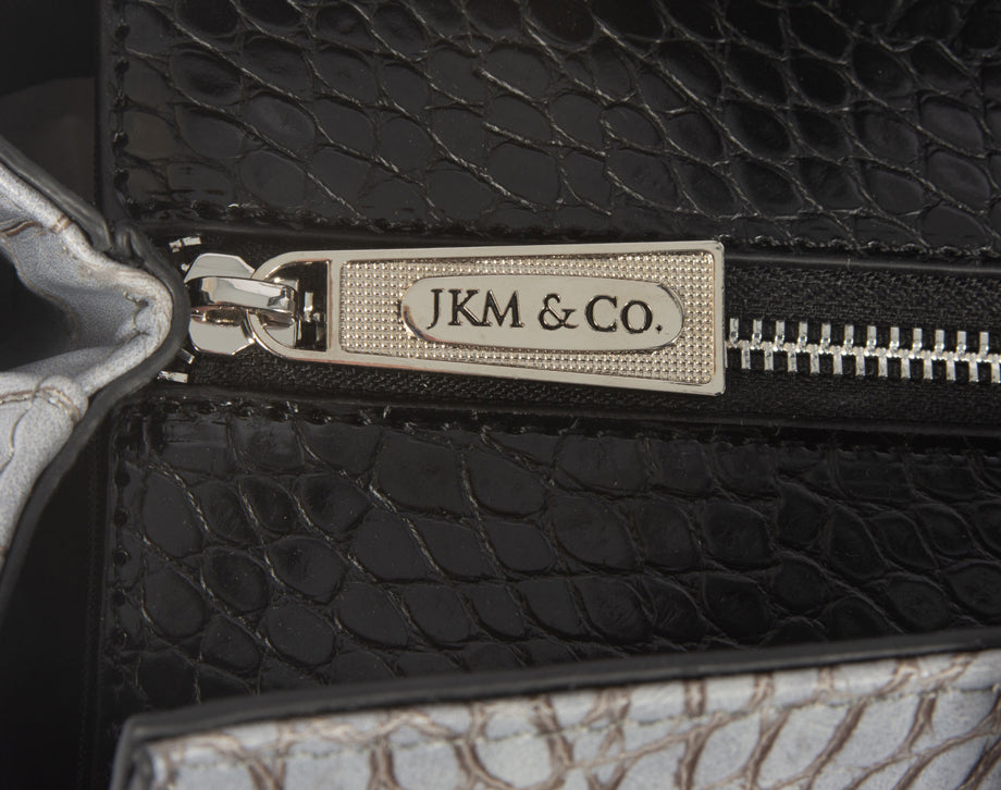 Top view of a business rolling laptop briefcase with grey alligator print, featuring a strong branded YKK zipper to secure the main compartment. This elegant, functional rolling briefcase for women offers ample storage and easy access, ideal for professional and travel needs.