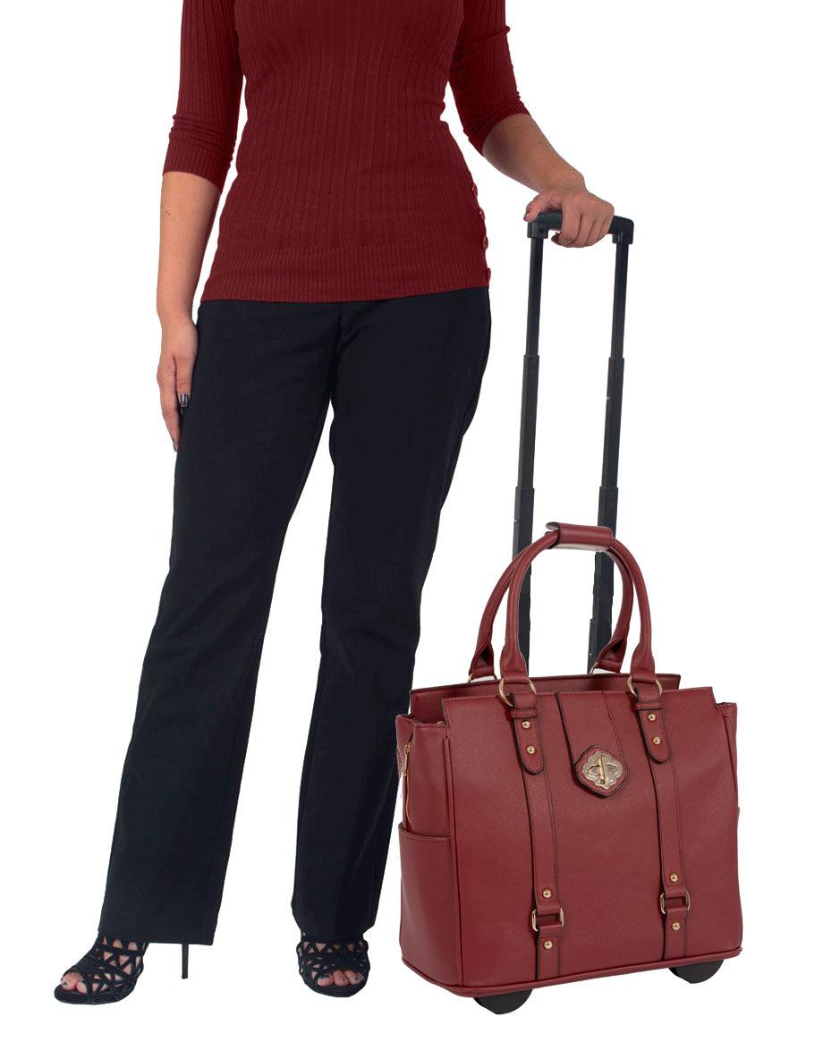 A businesswoman stands confidently with the Executive Burgundy laptop tote beside her, combining fashion and function. This bag is the perfect accessory to pair with cute professional clothes, ladies office attire, business casual outfits, and business professional outfits for women. Designed as a professional women's laptop briefcase with wheels, this laptop work bag brings executive elegance to everyday use while fitting laptops, tablets, files, water bottles, umbrellas, and other essentials.