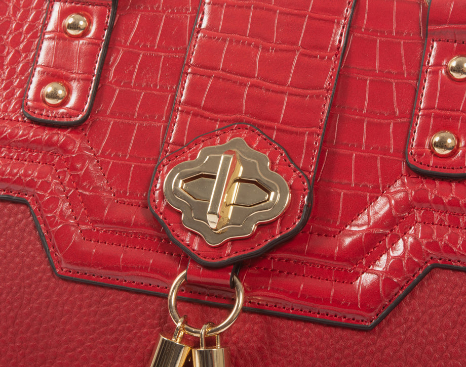 An up close image of the scarlet faux leather tote with laptop pocket. This feminine briefcase is the perfect anniversary gift for wife or birthday present for best friend. The red alligator and pebble texture is highlighted by the chic gold accents.